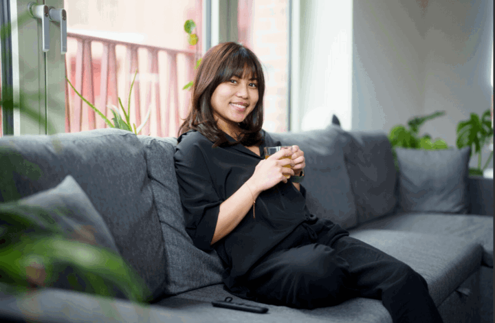 Woman sitting on sofa in London Living Rent home