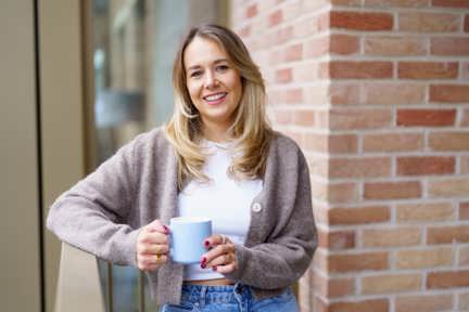 Woman standing on balcony of new build Shared Ownership home