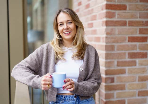 Woman standing on balcony of new build Shared Ownership home