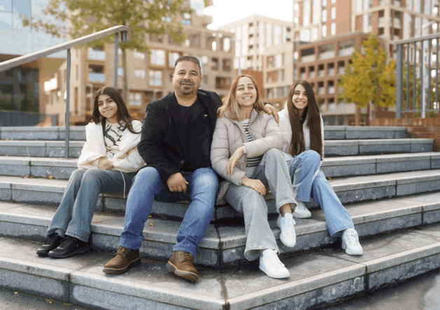 Family of four sat outside Southmere - Shared Ownership development
