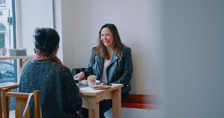 woman chatting to her friend in a cafe near Wharf Road