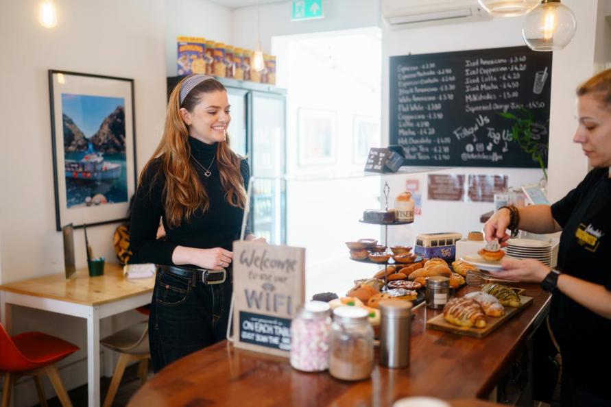 Woman standing at counter in Lakedale coffee cafe