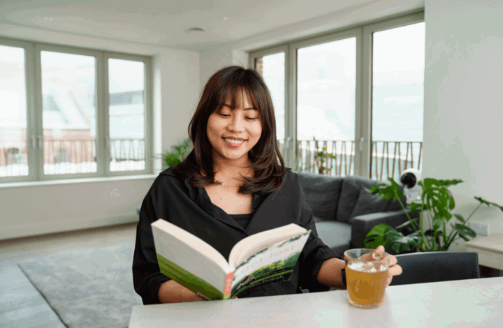 Woman reading a book in MacFarlane Place home