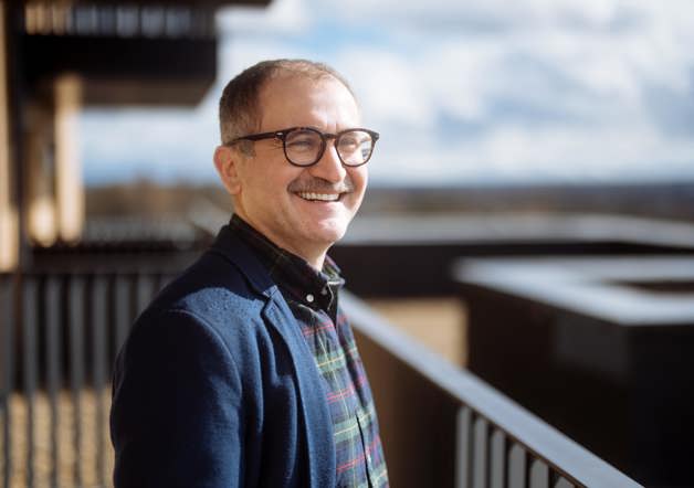 Man standing on balcony of his shared ownership home at Arden