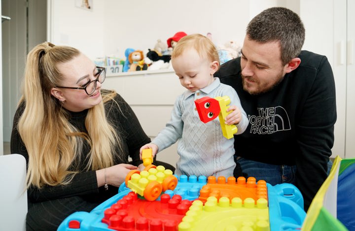 parents playing with their young child
