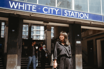 Woman standing outside White City station