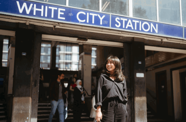 Woman standing outside White City station