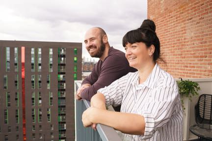 Robert and Kate - homeowners on balcony at Three Waters