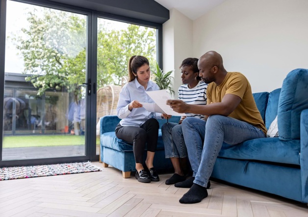Couple selling their home speaking with agent