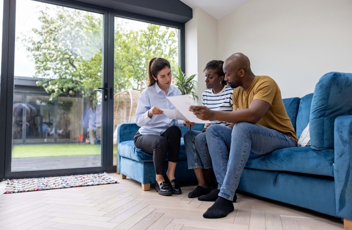 Couple selling their home speaking with agent
