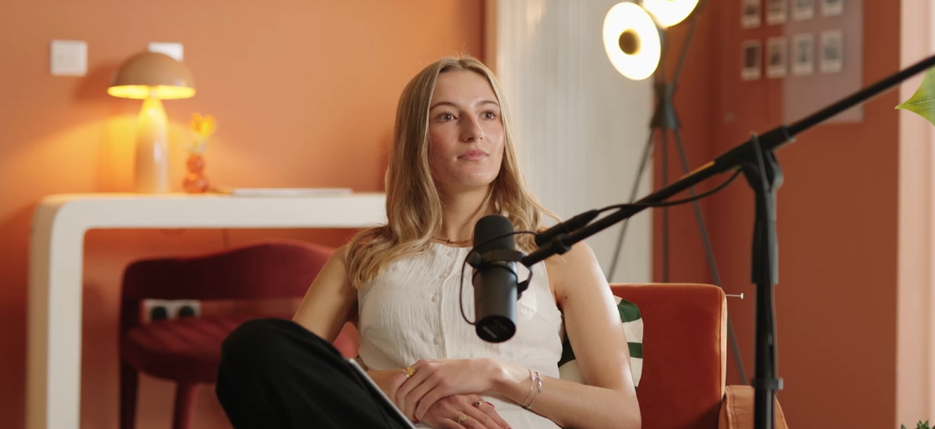 Woman sat on a chair with a microphone