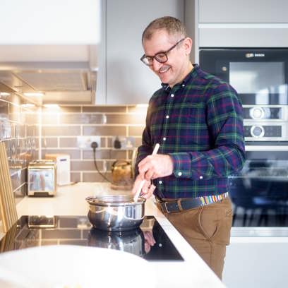 Man cooking in his open-plan kitchen