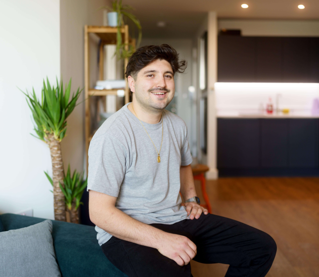 Clement in living room of Shared Ownership flat in Macfarlane Place