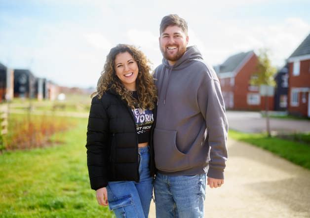 couple standing outside their Shared Ownership home in Essex