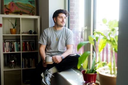 Homeowner sat on window sill of Shared Ownership home in Macfarlane Place