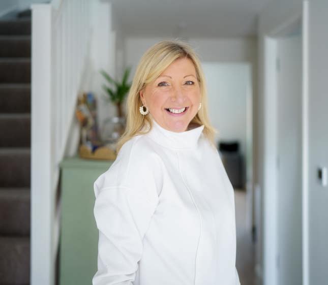 Woman standing in doorway of Shared Ownership house